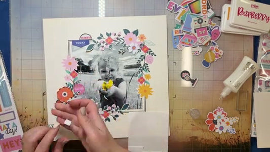 Scrapbook layout featuring a black and white baby photo framed with fussy cut floral patterned paper, puffy stickers, and stamped elements from February 2026 Hip Kits